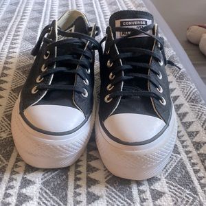 Black platform Converse sneakers.